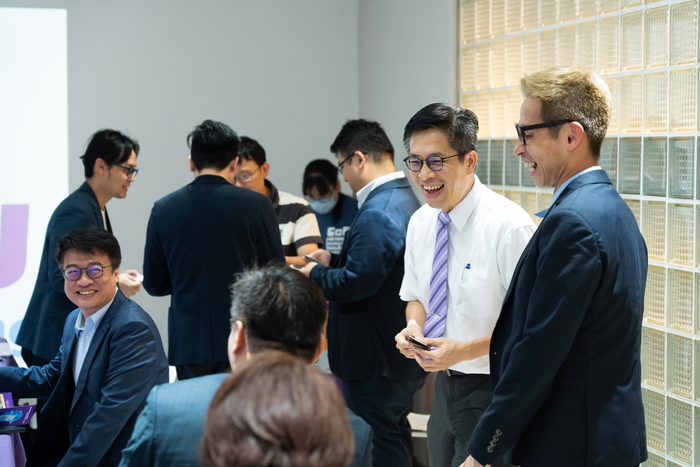 Industrial guests and our faculty engage in a pleasant interaction.