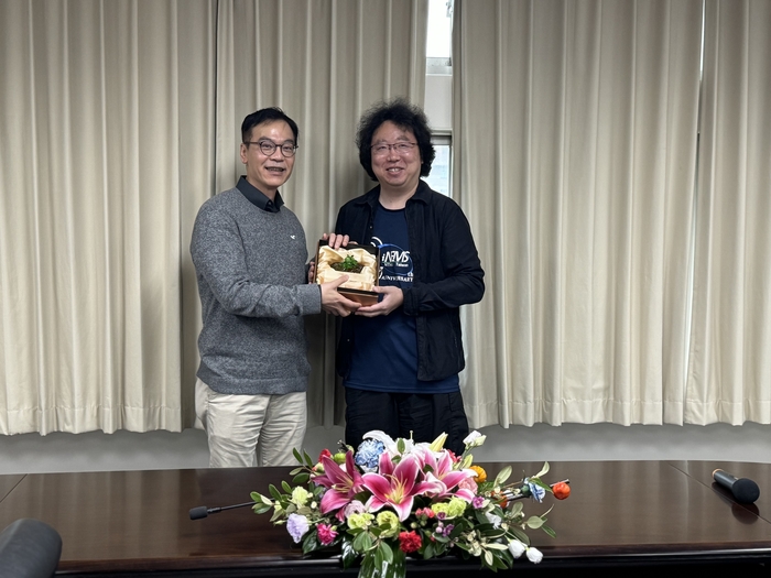 Dean Hu presents the Outstanding Teaching Award for Prof. Morikawa Kyojiro from the Institute of NEMS.
